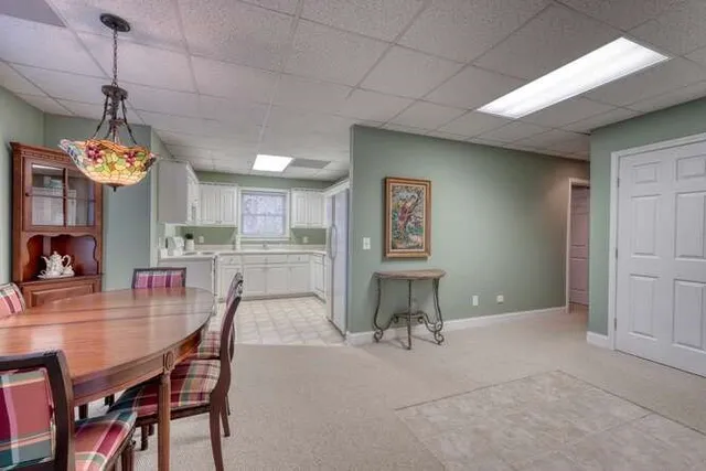 a spacious bedroom with a bed and a chandelier