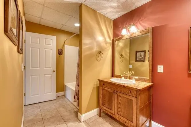 an aerial view of a house with a mountain