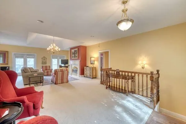 a living room with furniture and a chandelier