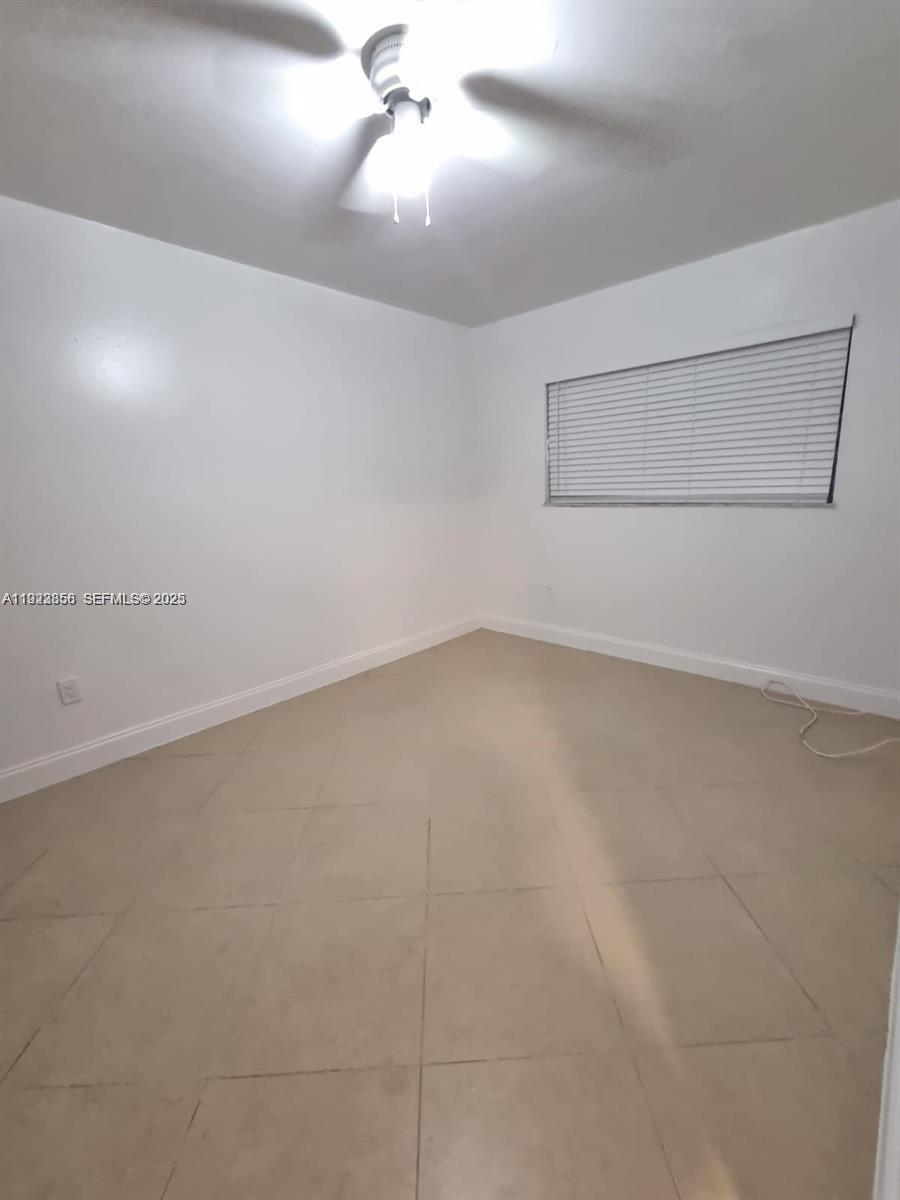 665 Northeast 83rd Terrace, Unit 112 Miami, FL 33138 - Photo 4 of 8 an empty room with a empty space and windows
