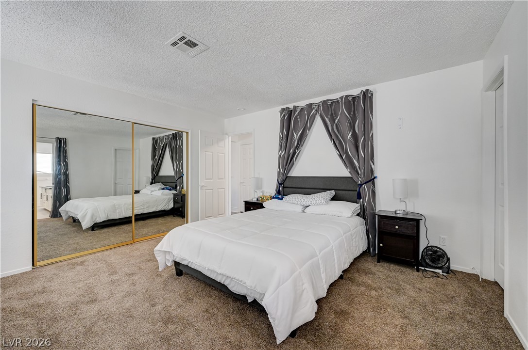1751 East Reno Avenue, Unit 228 Las Vegas, NV 89119 - Photo 21 of 39 A restful chamber showcasing ample floor space and practical mirrored closet doors for enhanced utility.
