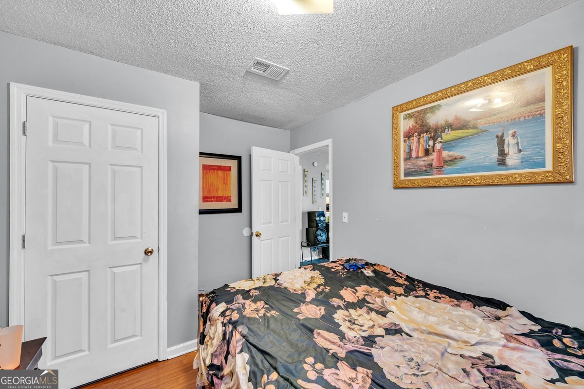 707 East 3rd Avenue Cordele, GA 31015 - Photo 14 of 21 a bedroom with bed and wooden floor