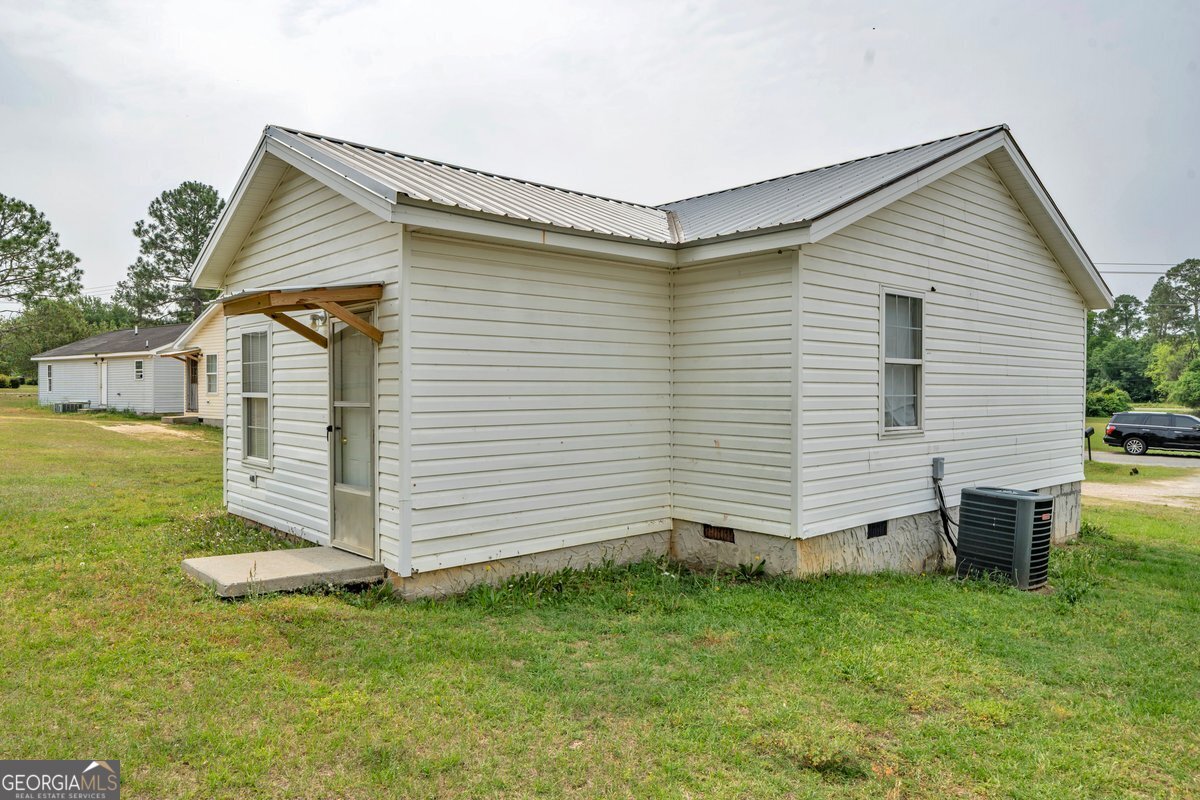 707 East 3rd Avenue Cordele, GA 31015 - Photo 17 of 21 a view of a house with a yard