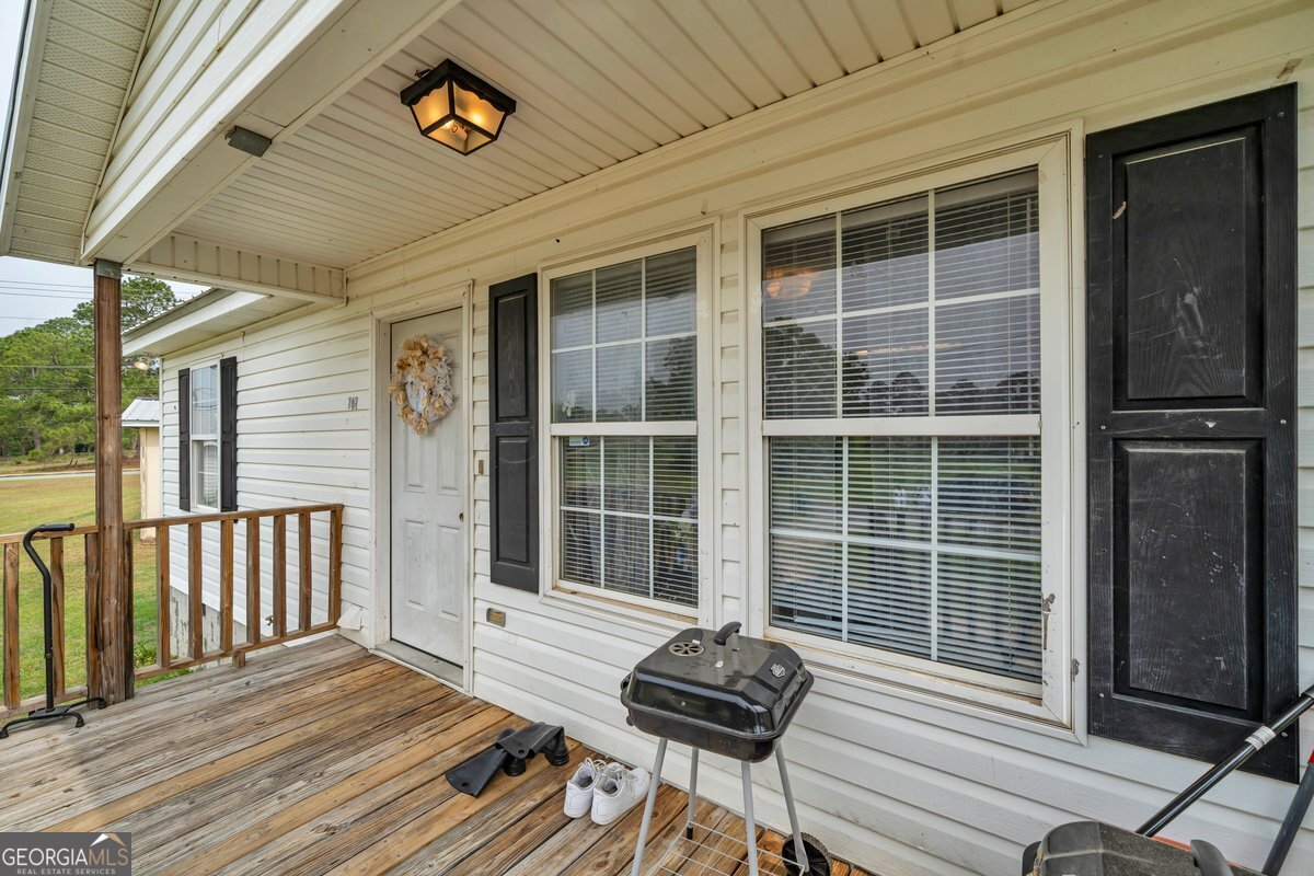 707 East 3rd Avenue Cordele, GA 31015 - Photo 2 of 21 a view of a deck with wooden floor and a yard
