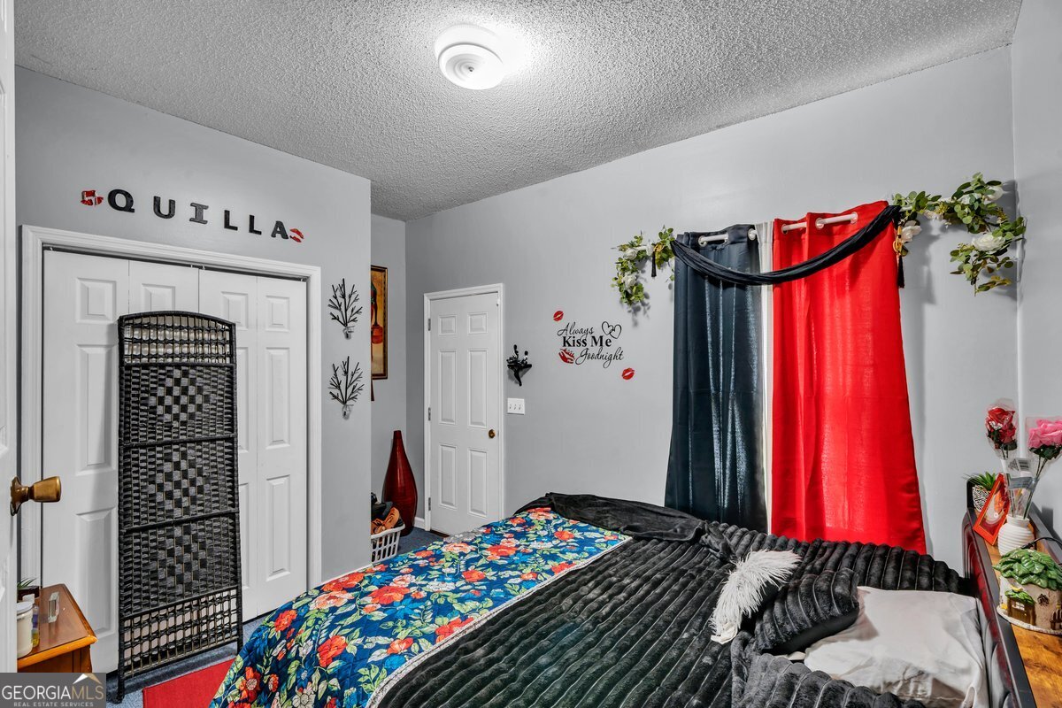 707 East 3rd Avenue Cordele, GA 31015 - Photo 9 of 21 a bedroom with a bed and a small closet