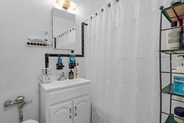 a bathroom with a sink vanity and a mirror