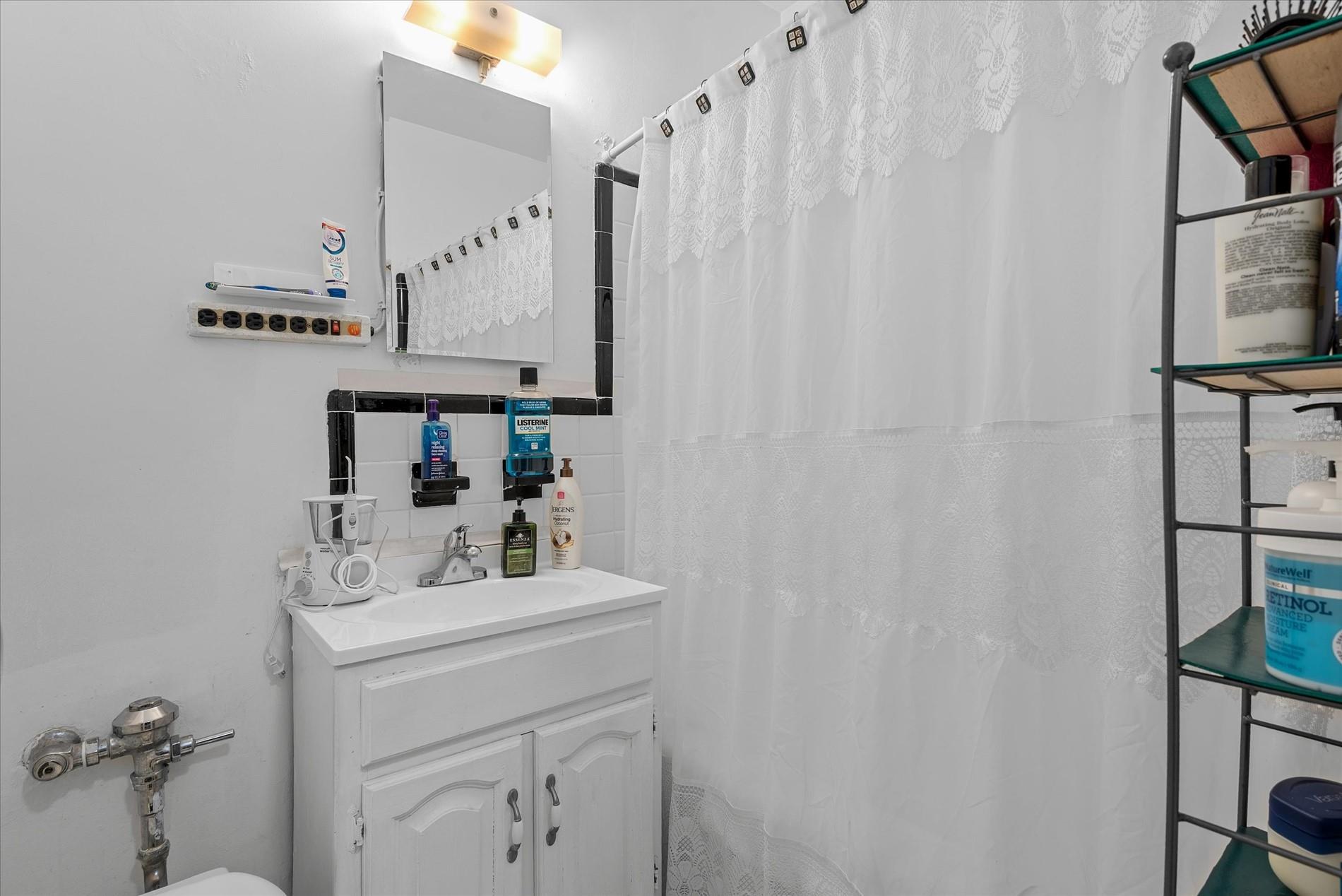 34-41 85th Street, Unit 4D Queens, NY 11372 - Photo 5 of 18 a bathroom with a sink vanity and a mirror