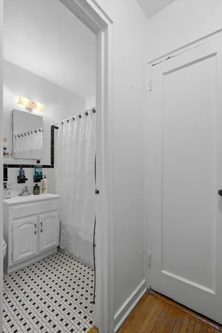 a bathroom with a sink a toilet a shower and a mirror