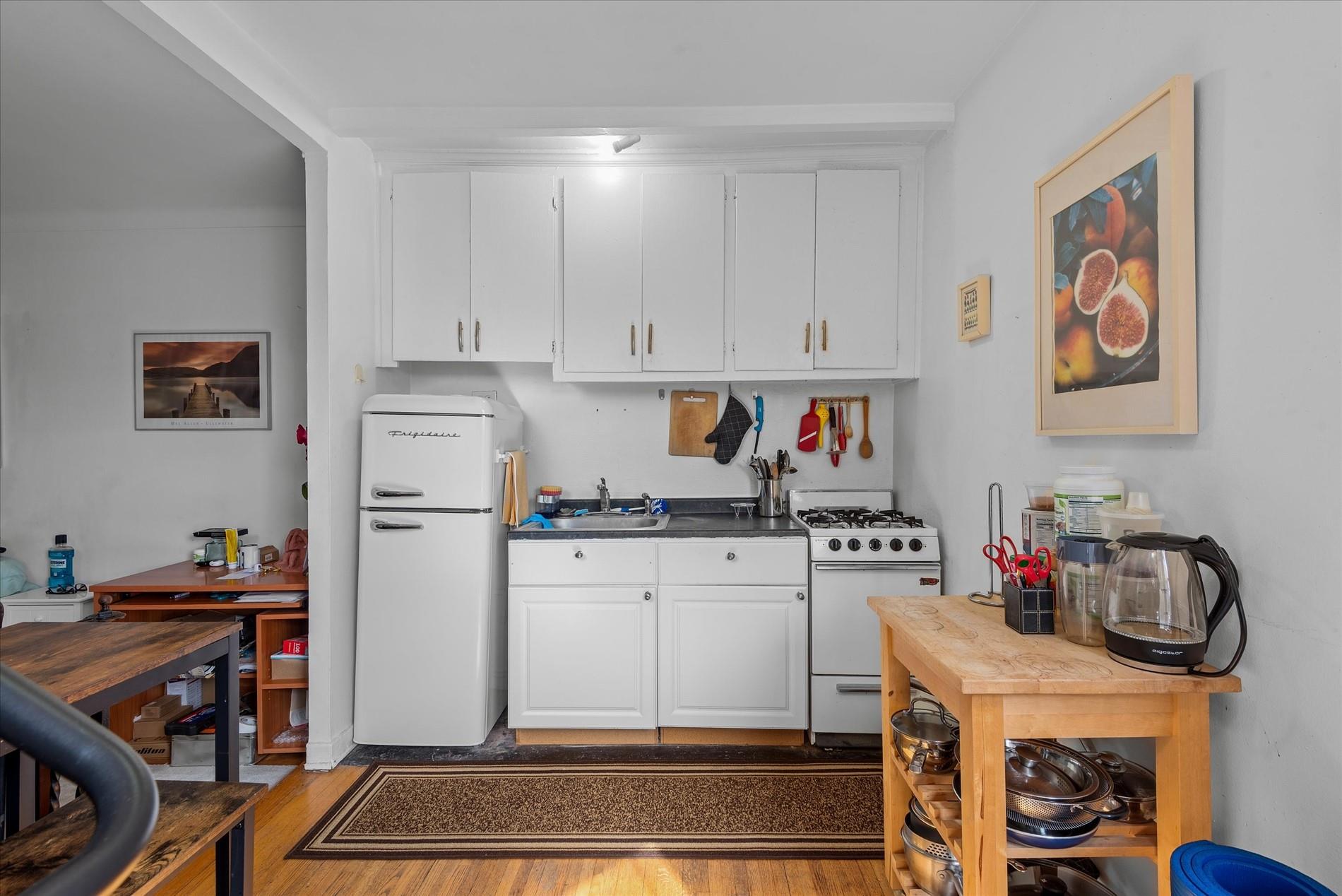34-41 85th Street, Unit 4D Queens, NY 11372 - Photo 7 of 18 a kitchen with stainless steel appliances granite countertop a refrigerator and a stove top oven