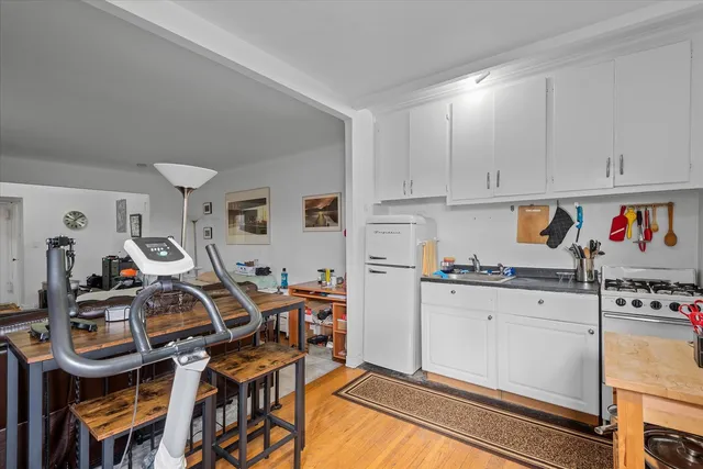 a kitchen with stainless steel appliances granite countertop a stove and white cabinets