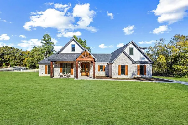 a front view of a house with a garden