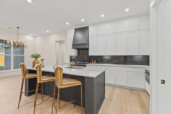 a large kitchen with kitchen island a sink stainless steel appliances and cabinets