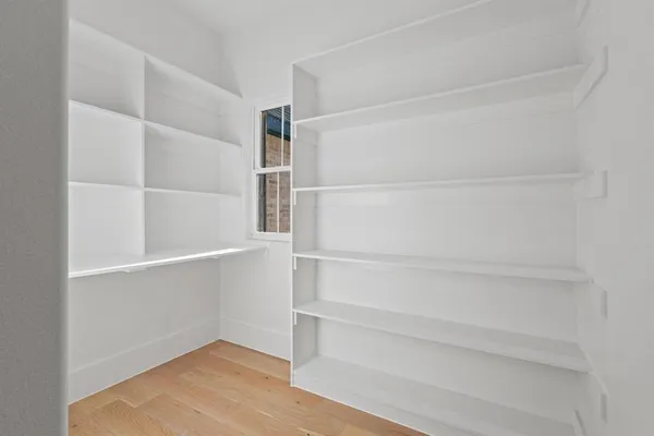 a bedroom with a bed couch and a window