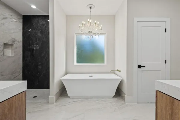 a bathroom with a bathtub and shower