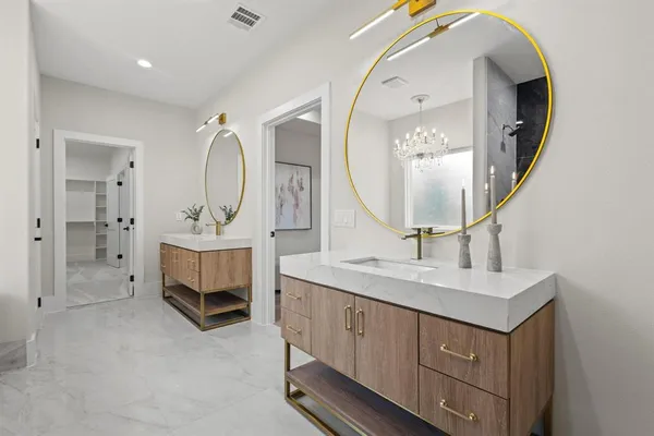 a bathroom with a toilet a sink a vanity and mirror