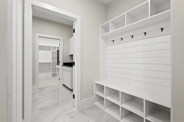 a kitchen with a refrigerator and white cabinets