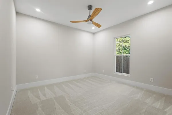 an empty room with windows and entrance