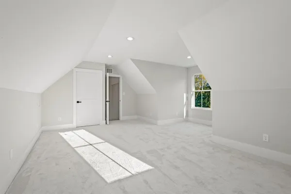 a kitchen with stainless steel appliances kitchen island granite countertop a stove a sink and white cabinets
