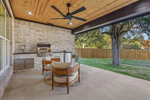 a view of a house with a backyard porch and sitting area