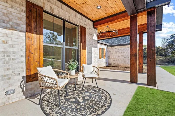 a view of a patio with a table and chairs