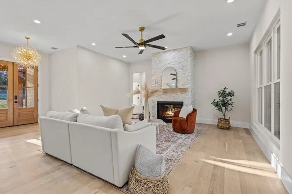 a living room with furniture kitchen view and a fireplace