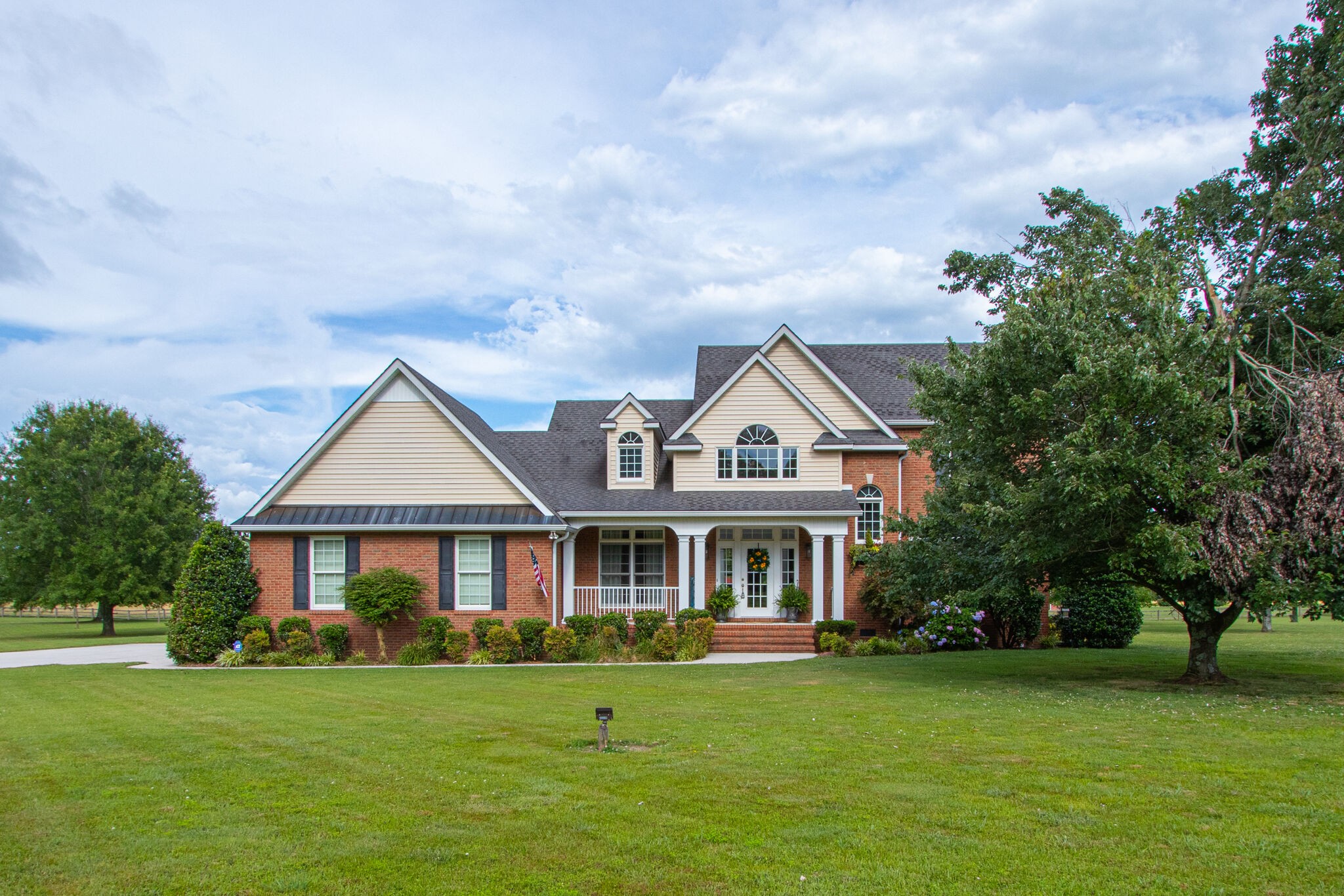 a front view of a house with a garden