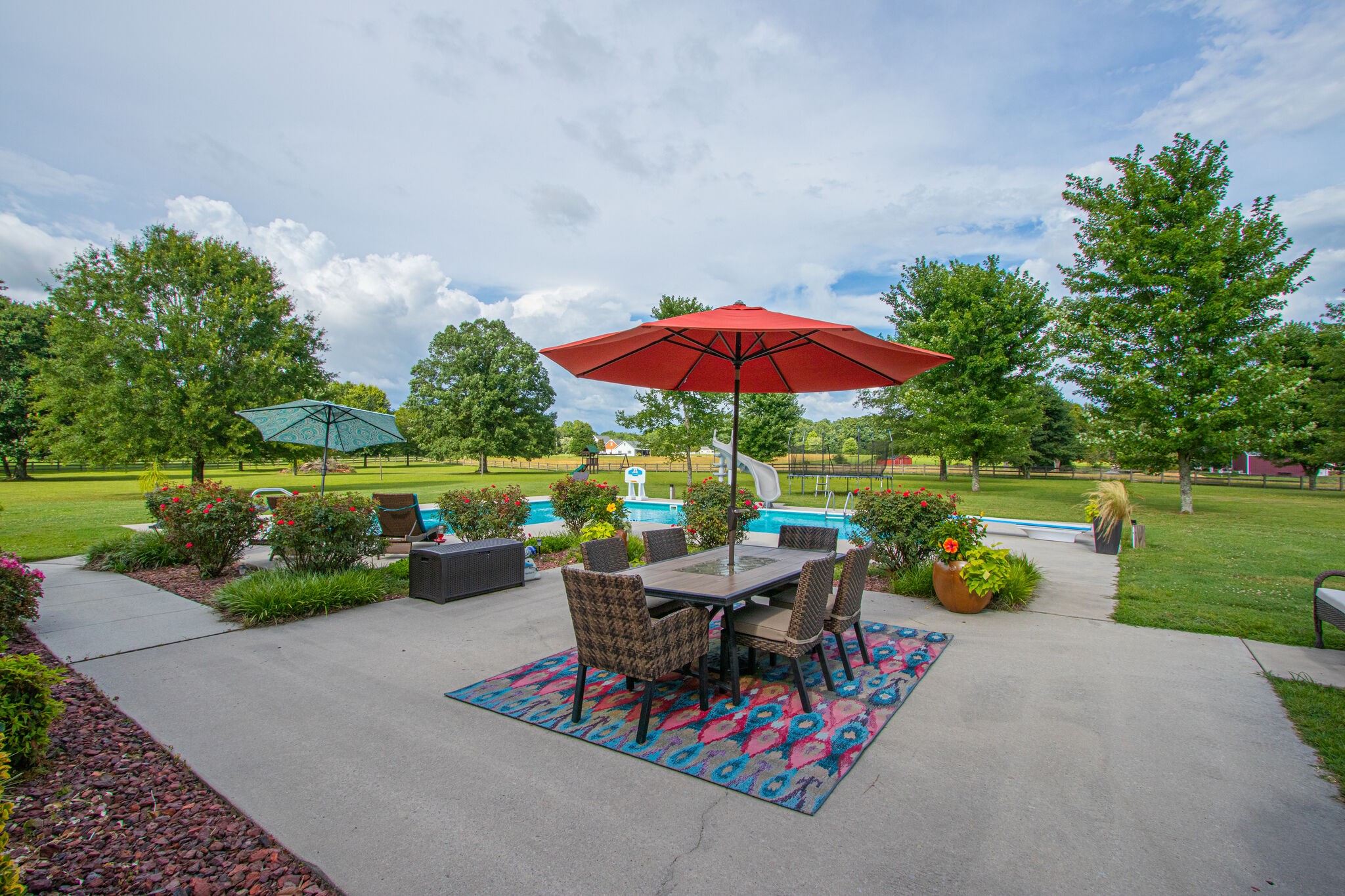 881 Urban Farms Road Manchester, TN 37355 - Photo 39 of 49 a view of a table and chairs under an umbrella in a park
