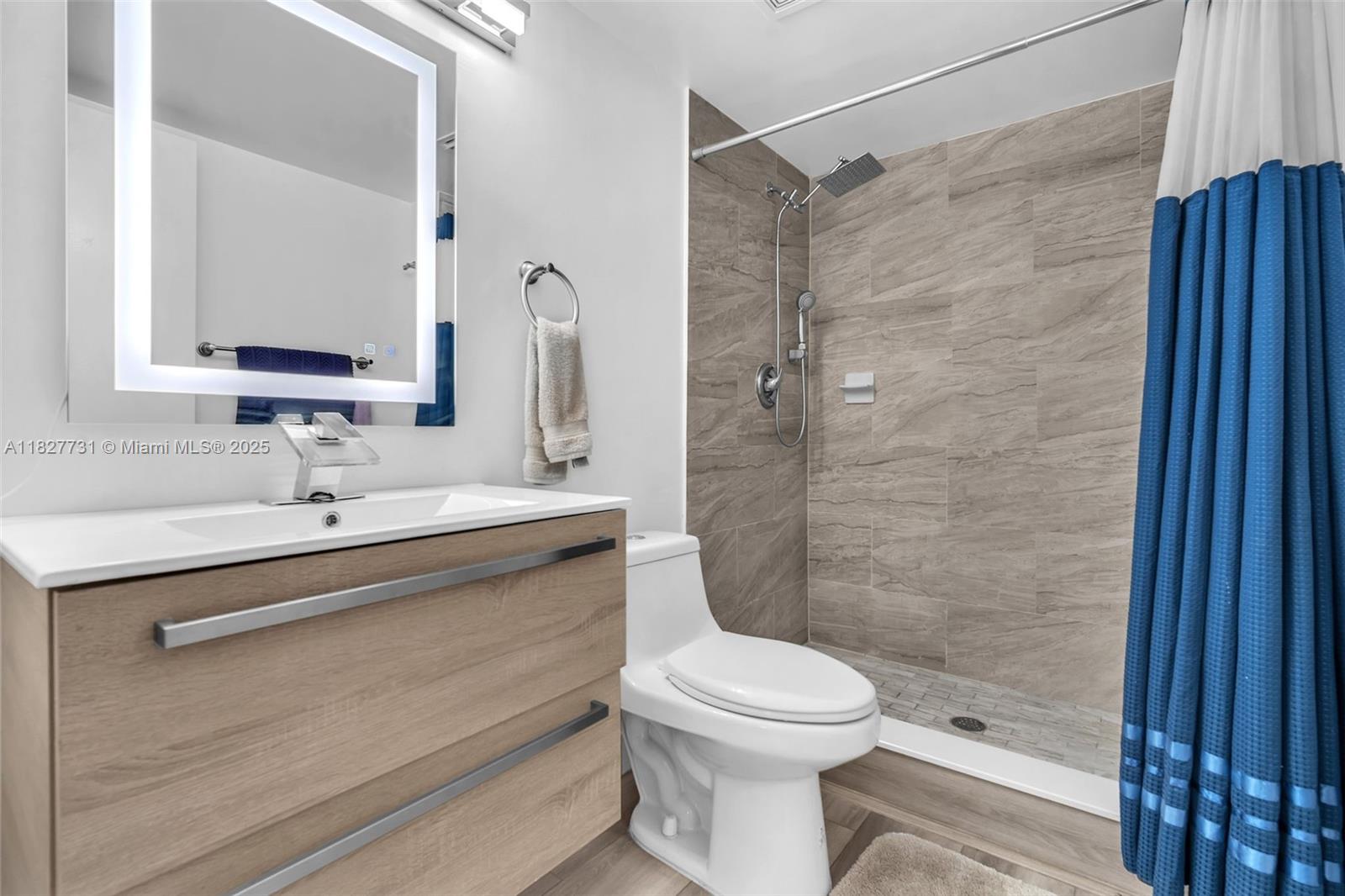 9525 Weldon Circle, Unit H305 Tamarac, FL 33321 - Photo 16 of 26 a bathroom with a sink a toilet and shower