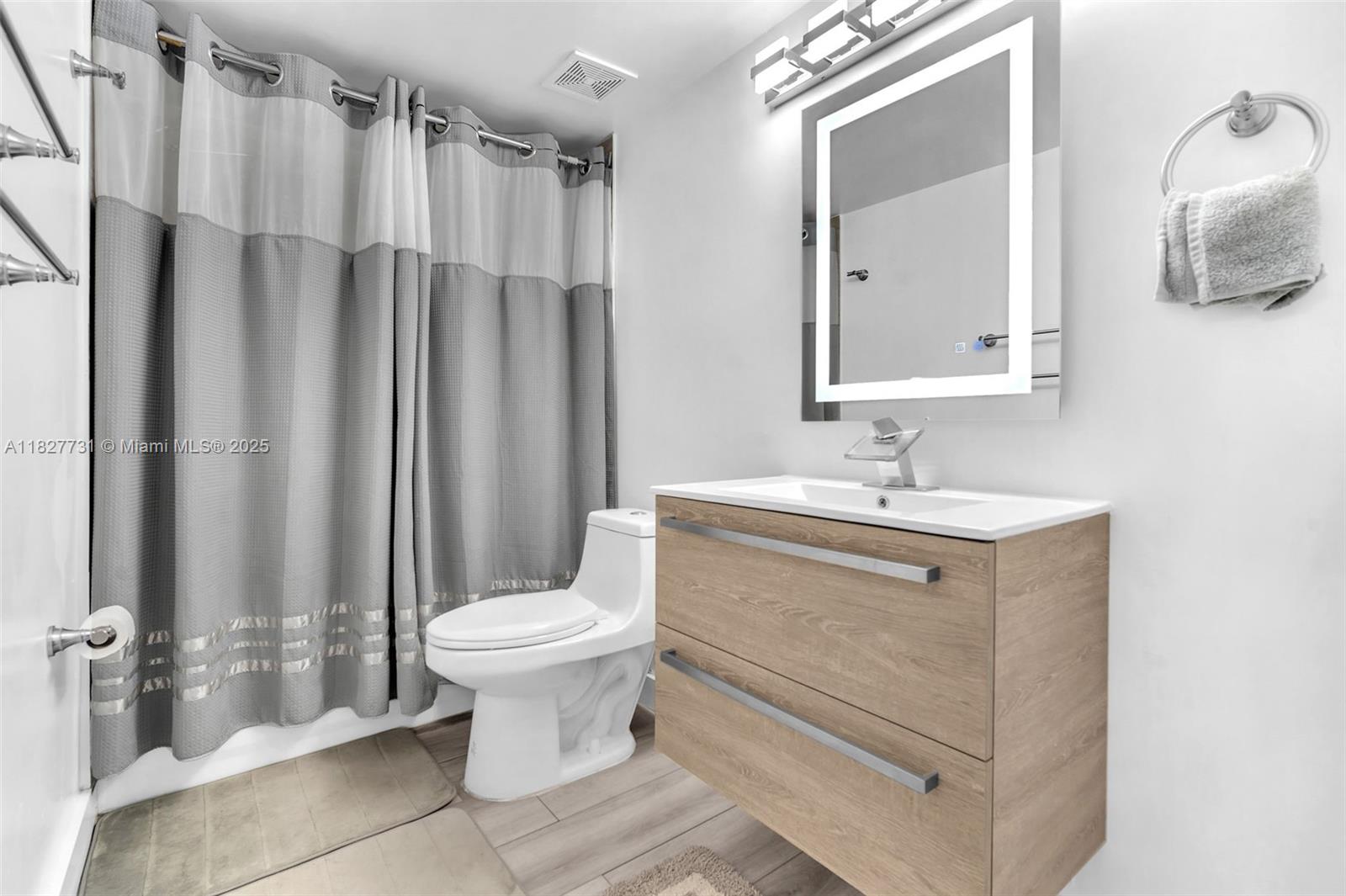 9525 Weldon Circle, Unit H305 Tamarac, FL 33321 - Photo 17 of 26 a bathroom with a sink toilet and shower