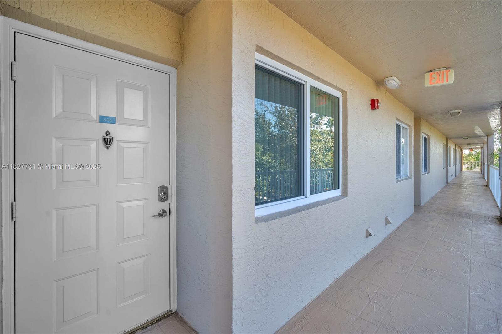 9525 Weldon Circle, Unit H305 Tamarac, FL 33321 - Photo 19 of 26 a view of an entryway with wooden floor and windows