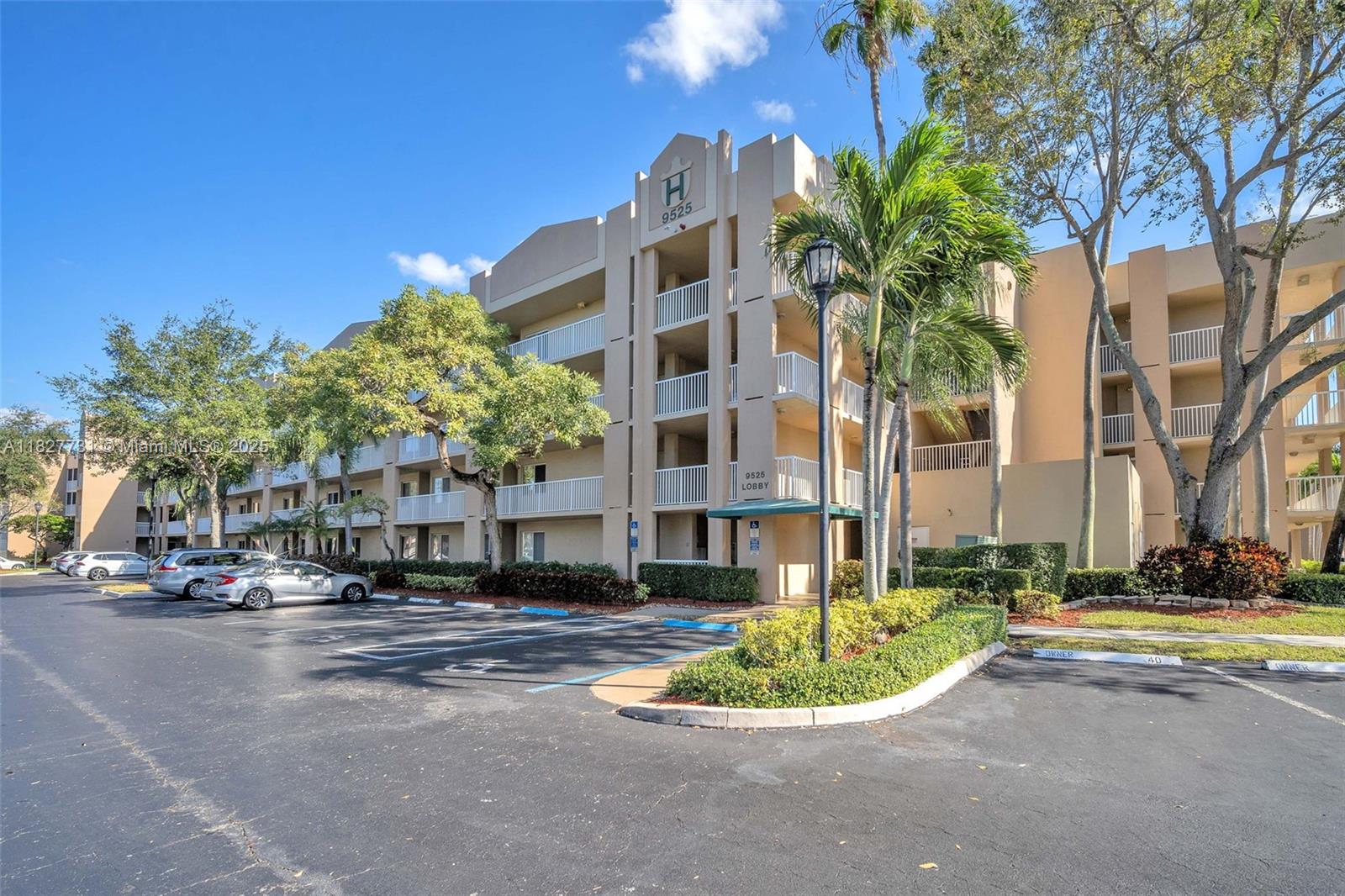9525 Weldon Circle, Unit H305 Tamarac, FL 33321 - Photo 20 of 26 a front view of a building with trees