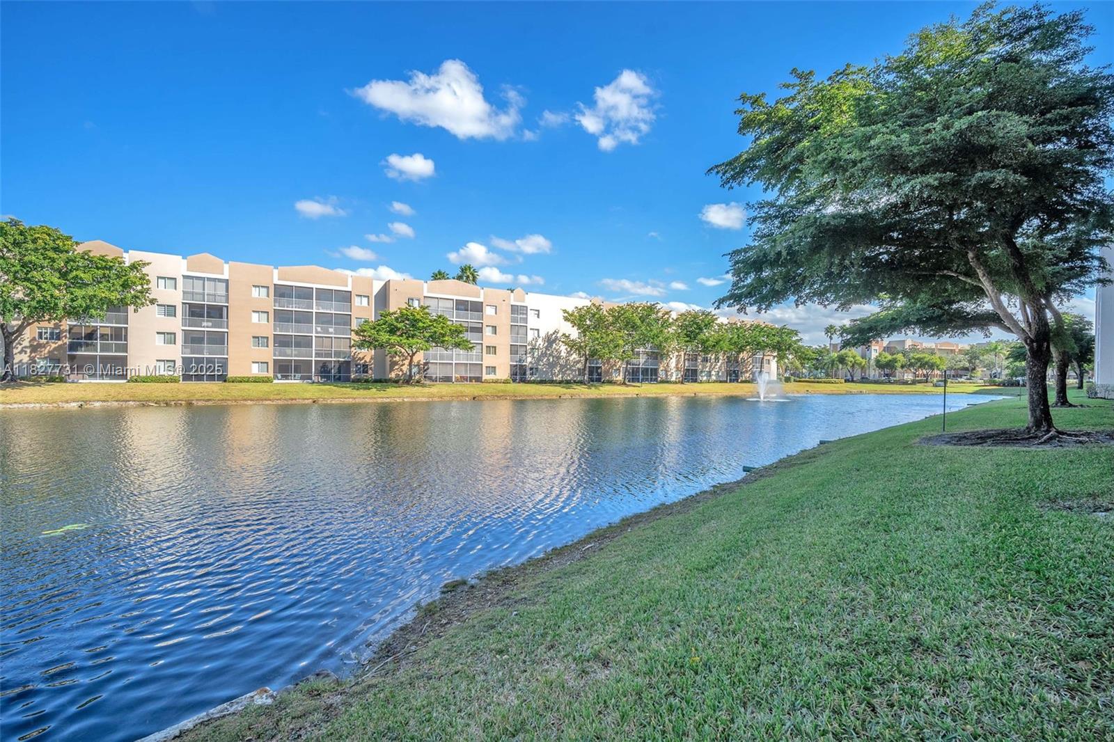 9525 Weldon Circle, Unit H305 Tamarac, FL 33321 - Photo 22 of 26 a view of a lake with houses