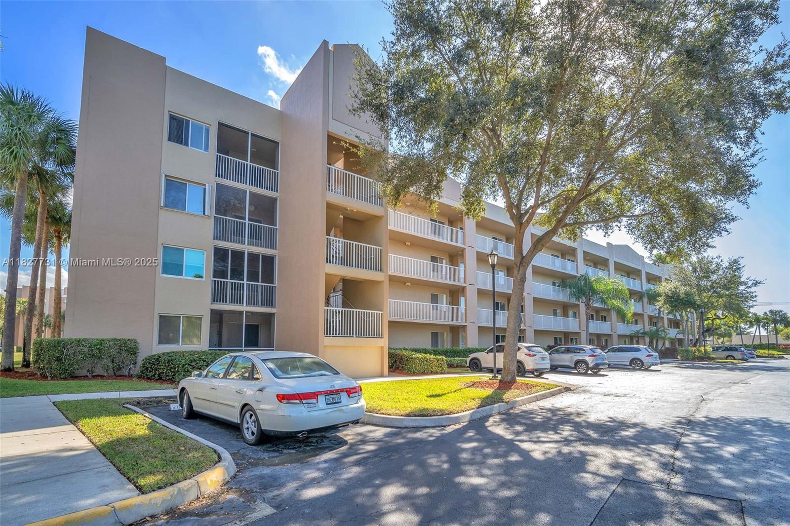 9525 Weldon Circle, Unit H305 Tamarac, FL 33321 - Photo 23 of 26 a swimming pool with outdoor seating and yard