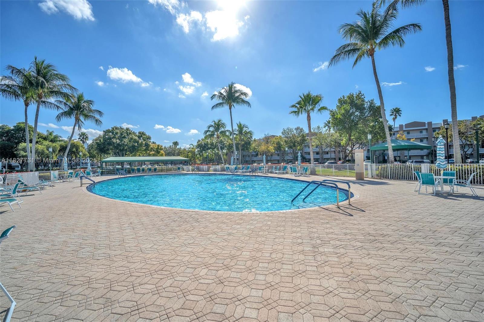 9525 Weldon Circle, Unit H305 Tamarac, FL 33321 - Photo 25 of 26 a view of a swimming pool with a yard
