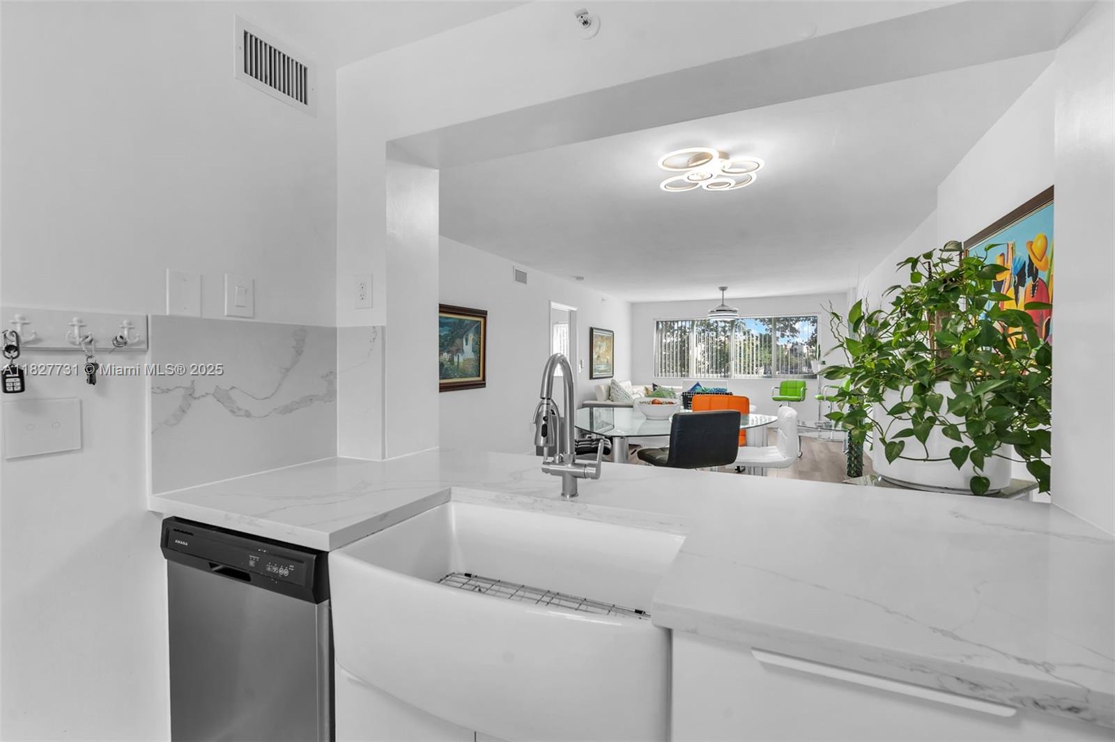 9525 Weldon Circle, Unit H305 Tamarac, FL 33321 - Photo 3 of 26 a kitchen with a sink and a refrigerator