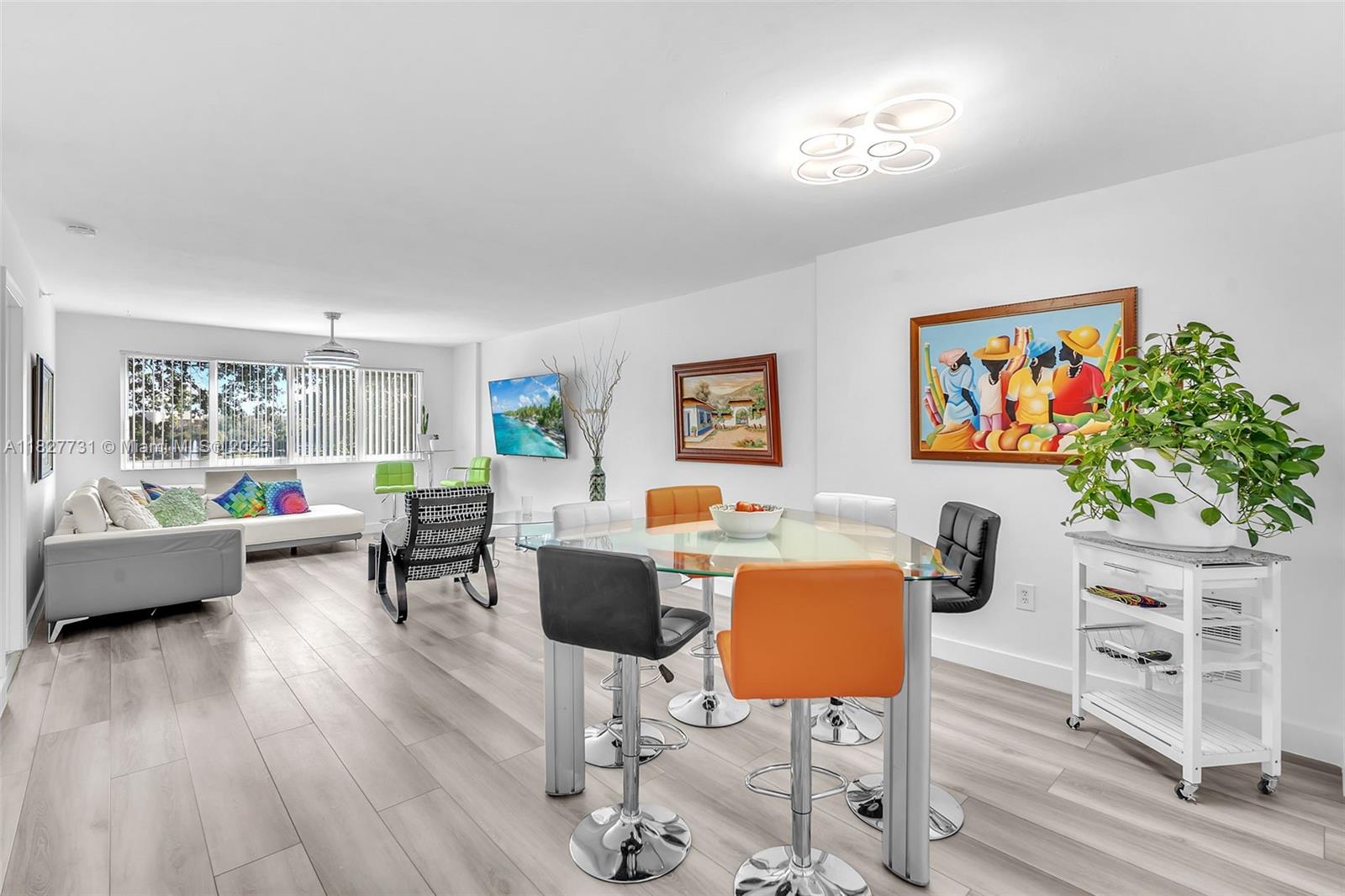 9525 Weldon Circle, Unit H305 Tamarac, FL 33321 - Photo 7 of 26 a living room with furniture and a wooden floor