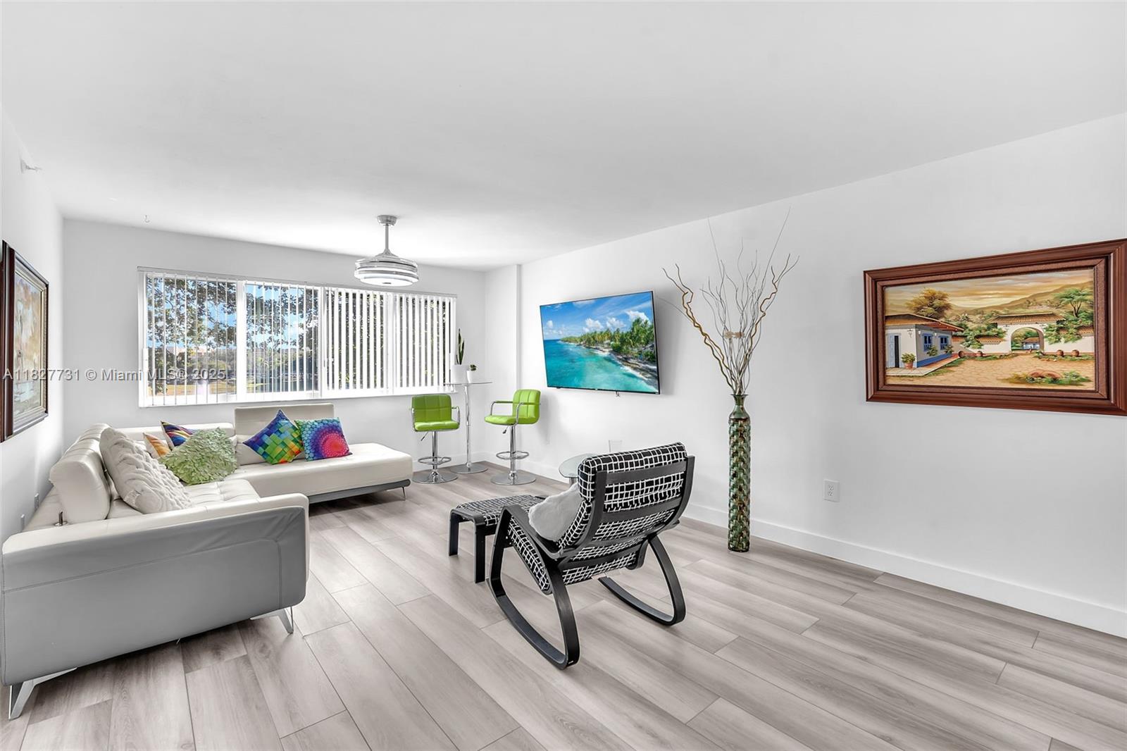 9525 Weldon Circle, Unit H305 Tamarac, FL 33321 - Photo 8 of 26 a living room with furniture and a large window