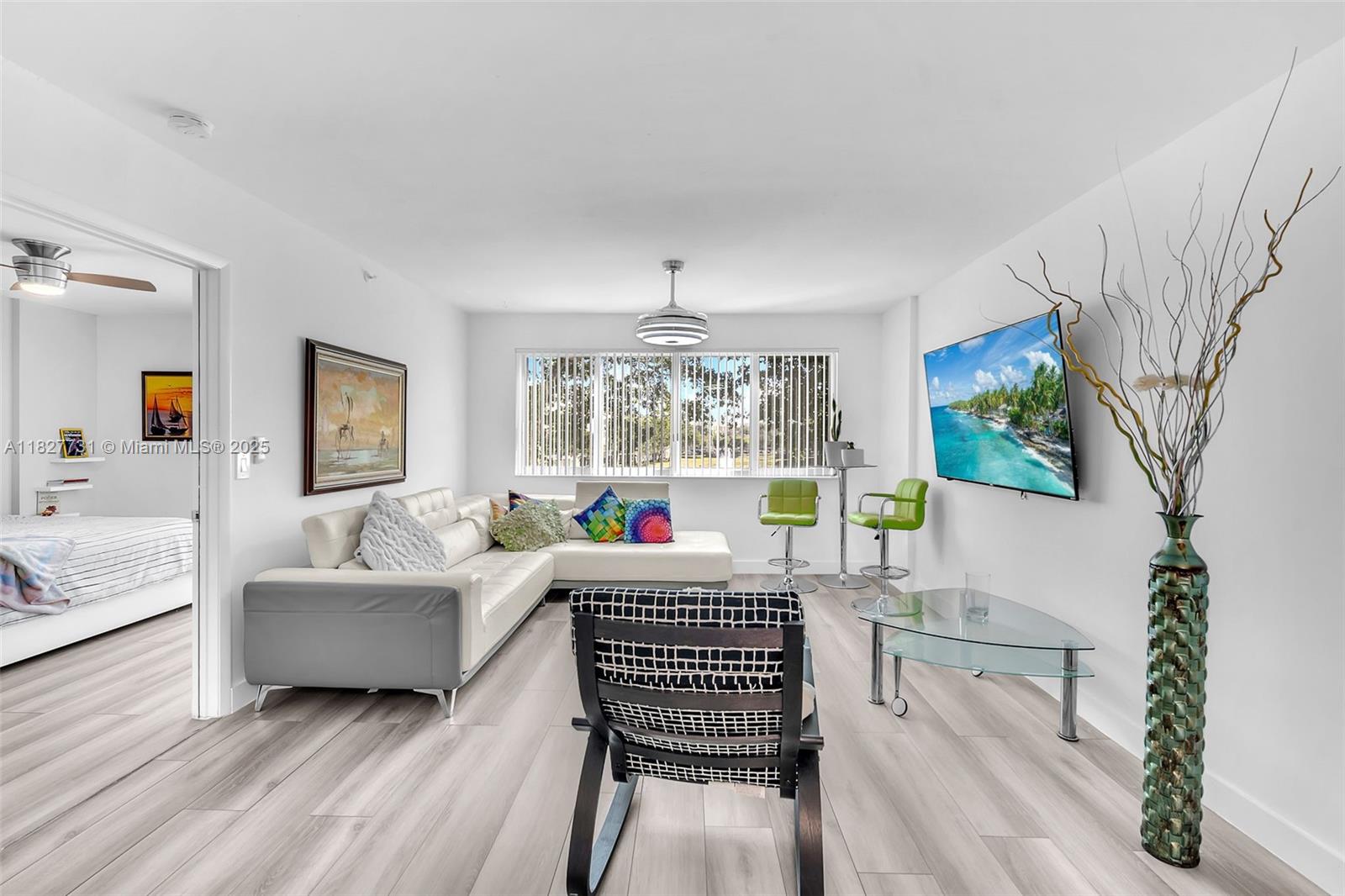 9525 Weldon Circle, Unit H305 Tamarac, FL 33321 - Photo 10 of 26 a living room with furniture and a large window