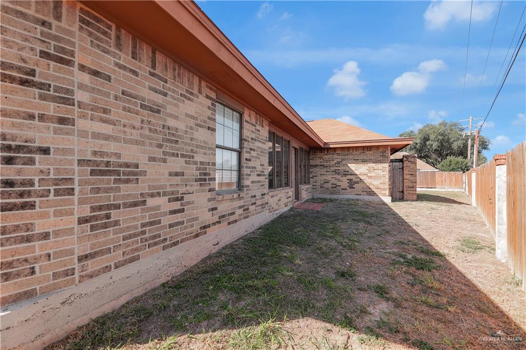 7008 North 30th Street McAllen, TX 78504 - Photo 14 of 18 a view of a brick house with a yard