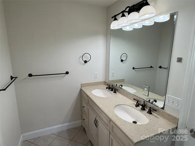 a bathroom with a sink double vanity and a mirror