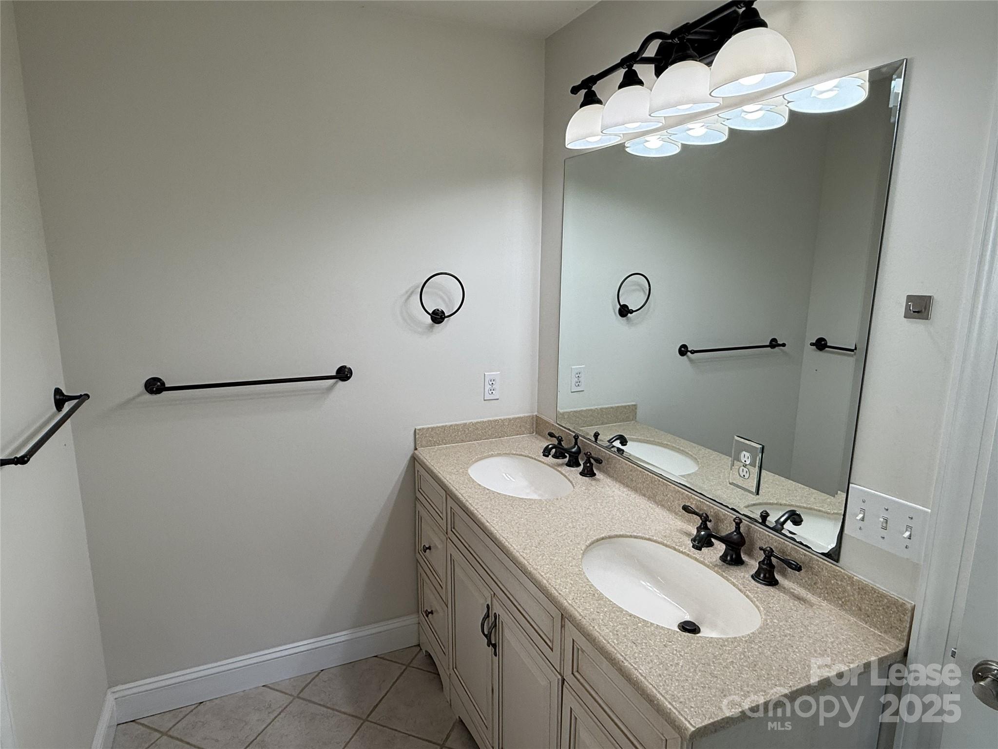 350 Melbourne Court Charlotte, NC 28209 - Photo 16 of 22 a bathroom with a sink double vanity and a mirror
