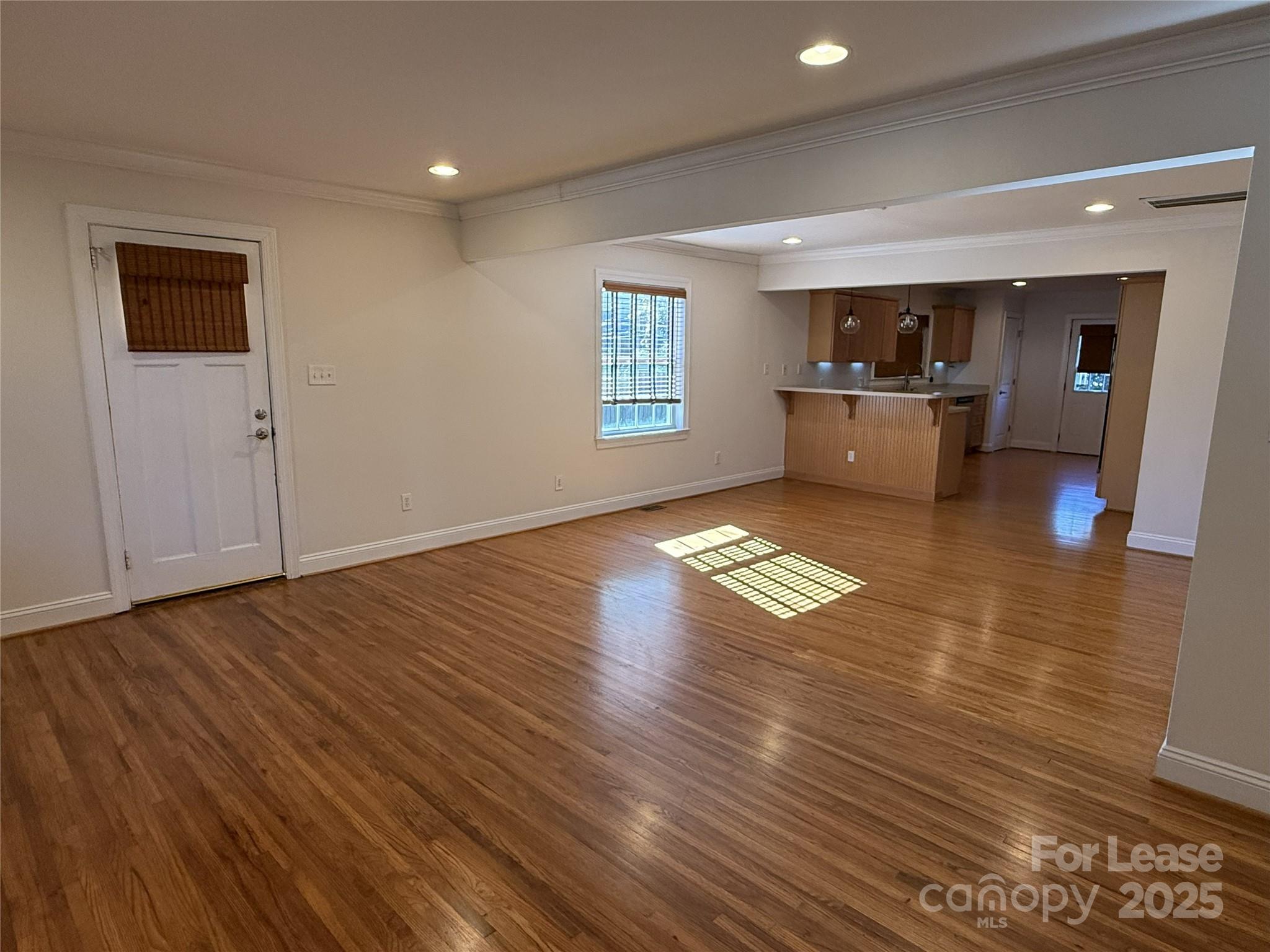 350 Melbourne Court Charlotte, NC 28209 - Photo 4 of 22 a view of empty room with wooden floor and kitchen view