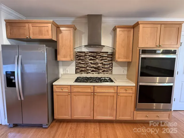 a kitchen with cabinets and stainless steel appliances