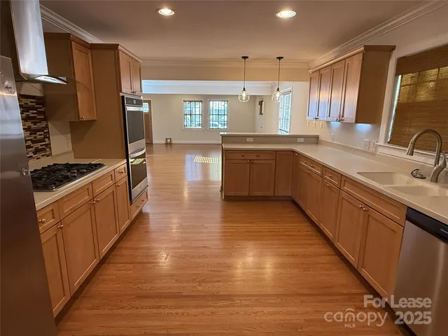 a kitchen with stainless steel appliances granite countertop a sink counter space and cabinets