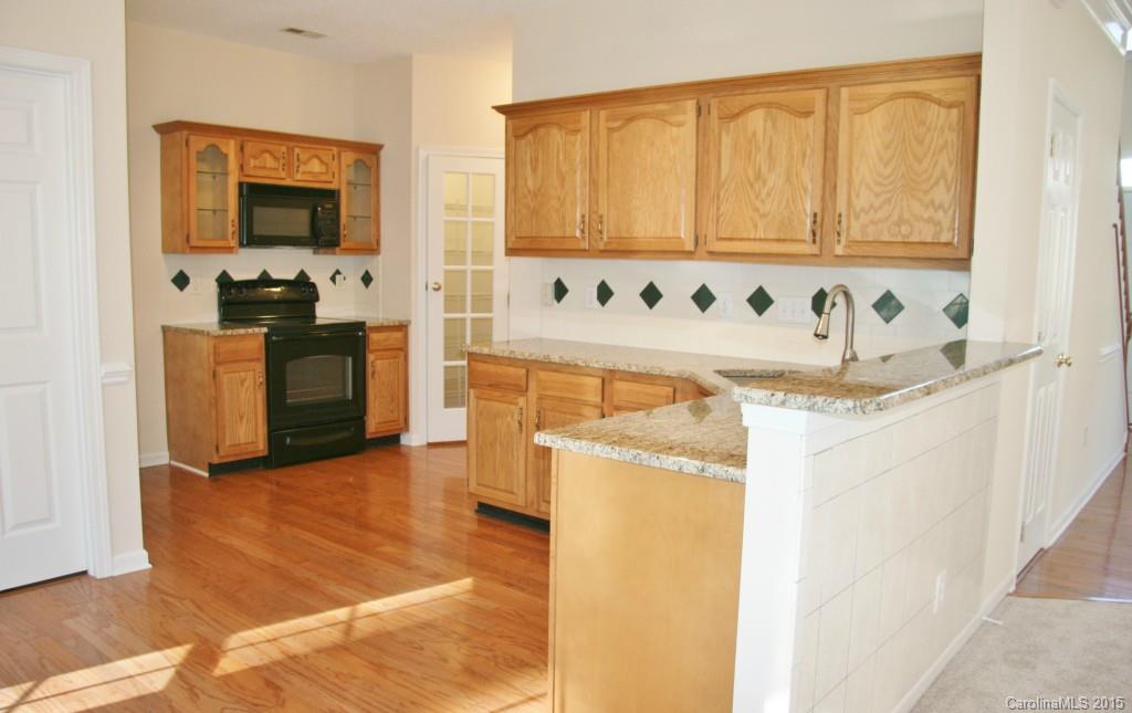 6714 Reedy Creek Road, Unit 2 Charlotte, NC 28215 - Photo 3 of 23 a kitchen with stainless steel appliances granite countertop a stove a microwave and a refrigerator