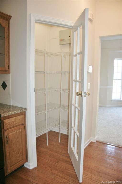 6714 Reedy Creek Road, Unit 2 Charlotte, NC 28215 - Photo 5 of 23 a view of a hallway with wooden floor and cabinet