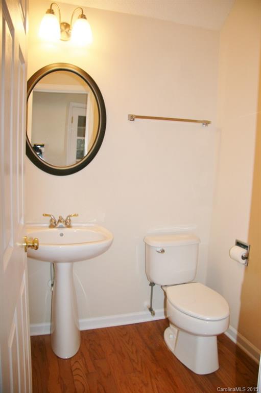 6714 Reedy Creek Road, Unit 2 Charlotte, NC 28215 - Photo 6 of 23 a bathroom with a toilet sink and mirror