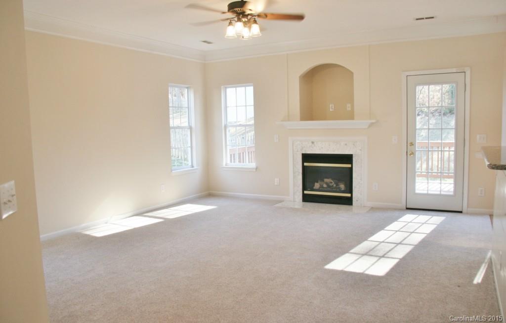 6714 Reedy Creek Road, Unit 2 Charlotte, NC 28215 - Photo 8 of 23 an empty room with windows and fireplace