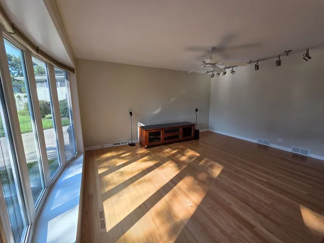 a view of a room with wooden floor and a balcony