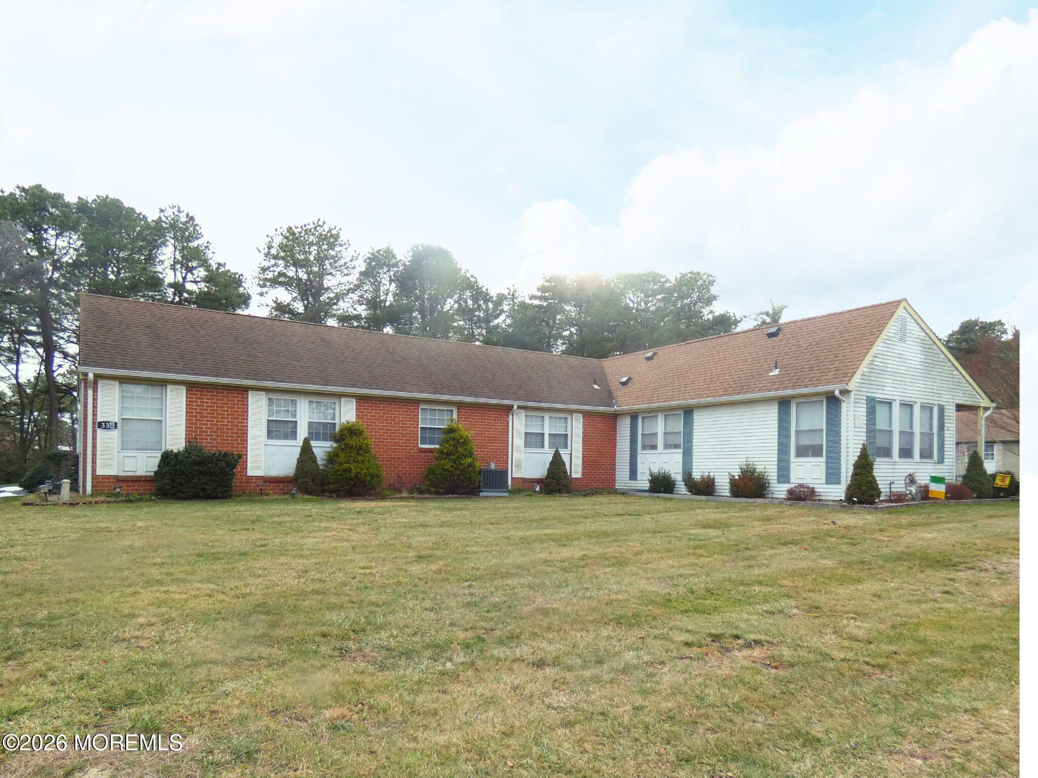 33D Medford Road, Unit A Manchester Township, NJ 08759 - Photo 23 of 24 a big house with a big yard and large trees